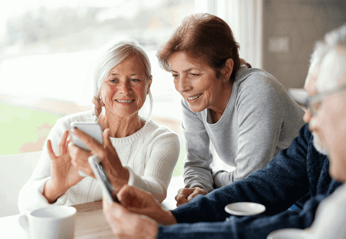 an elderly women looking at something on the phone