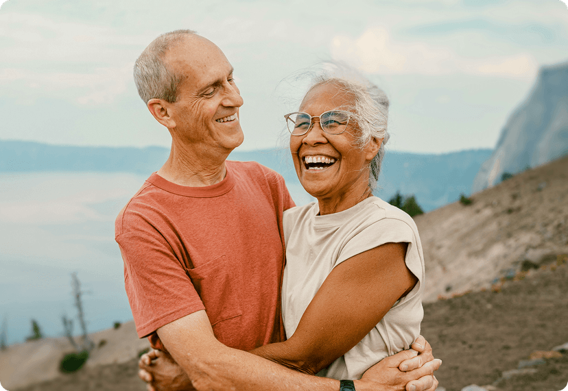 A retiree couple smiling outside