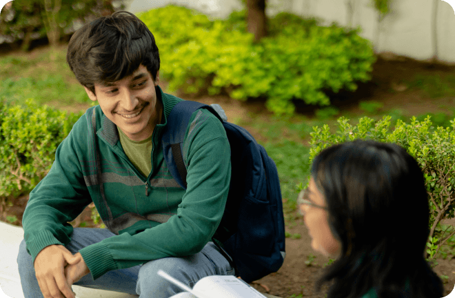 2 students smiling and looking at each other