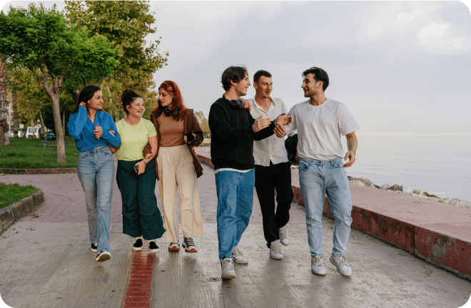 A group of friends walking near the sea