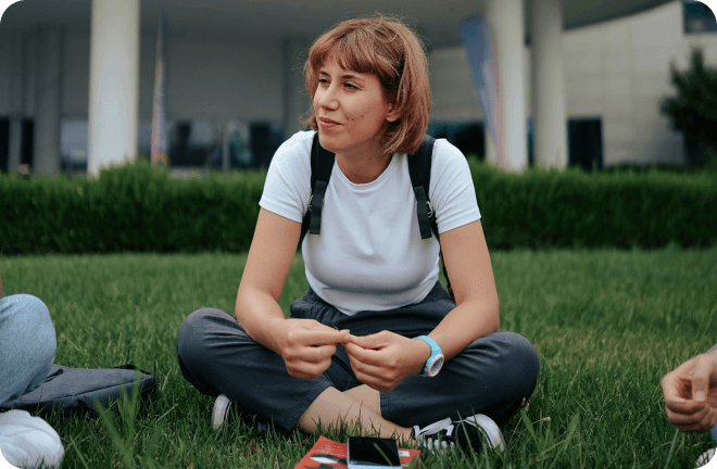 Young woman sitting on the grass 