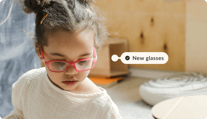 a child with some glasses and a tag