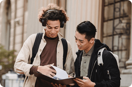 People standing and looking at book
