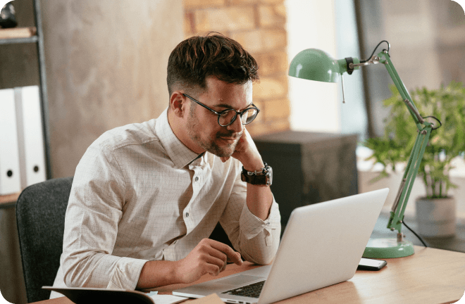 A man focused in front of his laptop