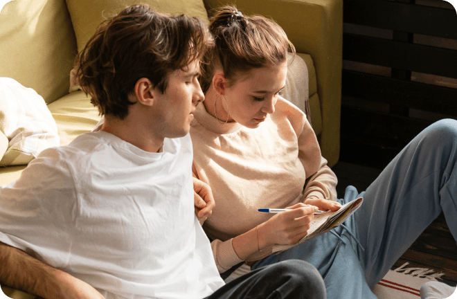 a couple writing something on a book