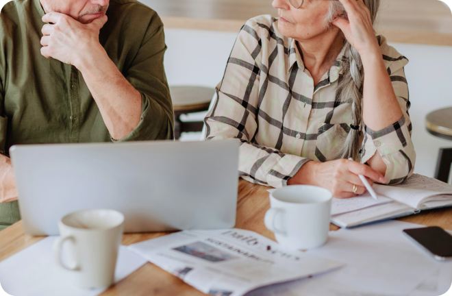 A middle aged couple in front of a computer