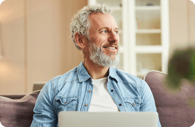 Man smiling with his laptop