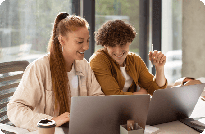 2 friends looking to their laptops
