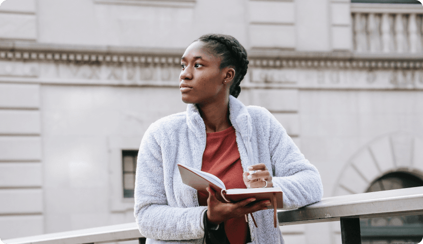 Woman standing with a book in hand