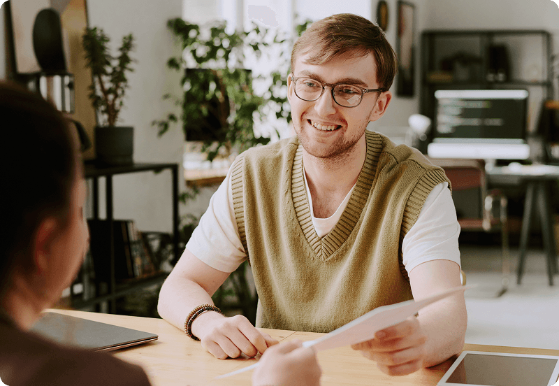 Writer handing draft to insurance expert for review