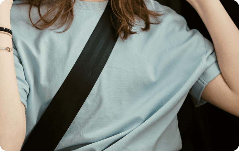 Girl in a car with a safety belt on.