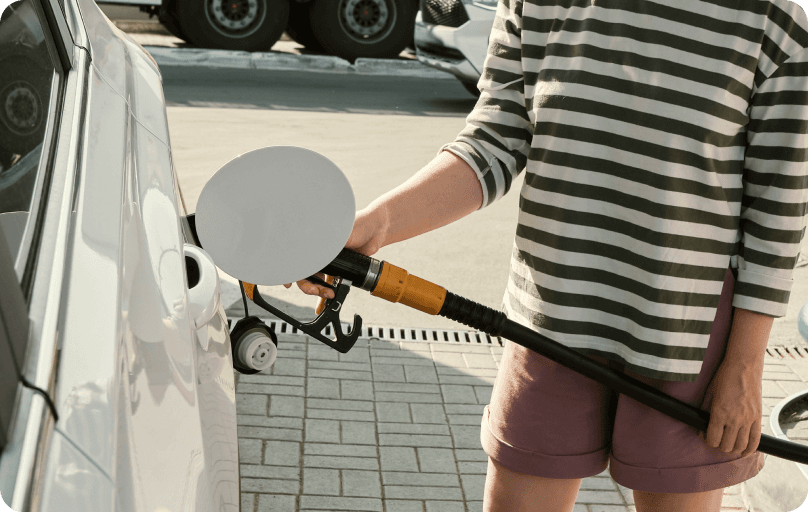Person filling in petrol on a gas station.