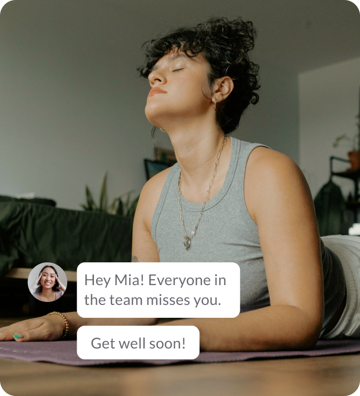 Woman exercising in a relaxed position at home. A tag in a corner showing a message from her colleague reads "Hey Mia! Everyone in the team misses you. Get well soon!".