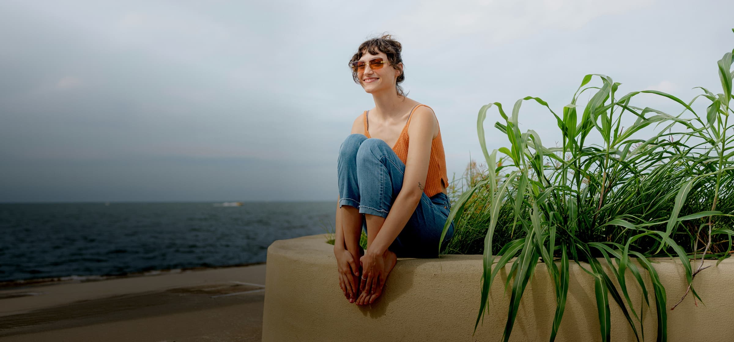 A girl sitting on the beach.