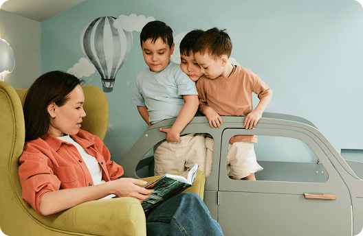 A mom and her two kids reading a fairytale