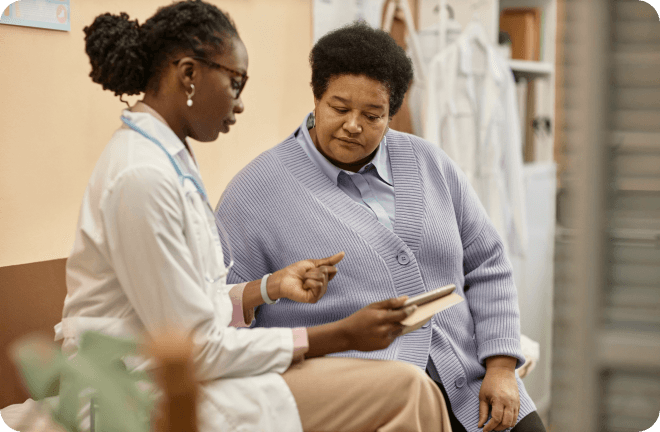 A middle-aged woman talking with a doctor.