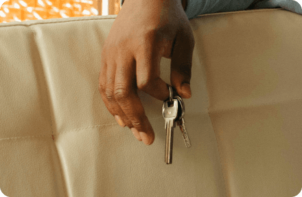 A hand holding apartment keys.