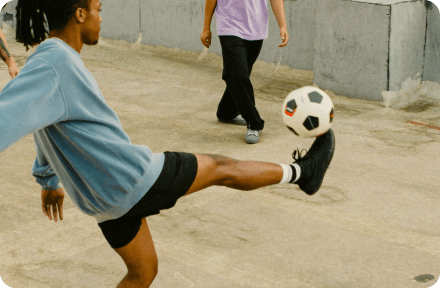 Two people playing with a football.