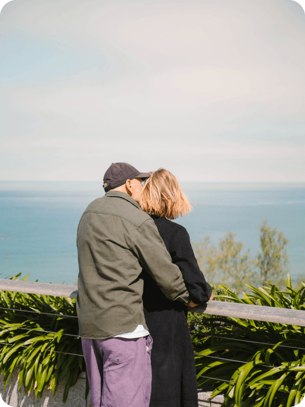 Older couple on vacation looking at a see view.
