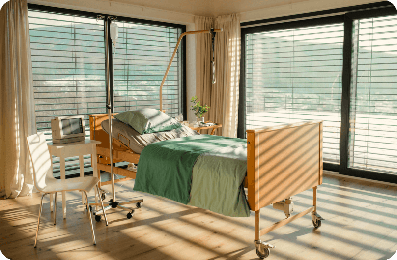 A private hospital room with a bed and medical equipment.