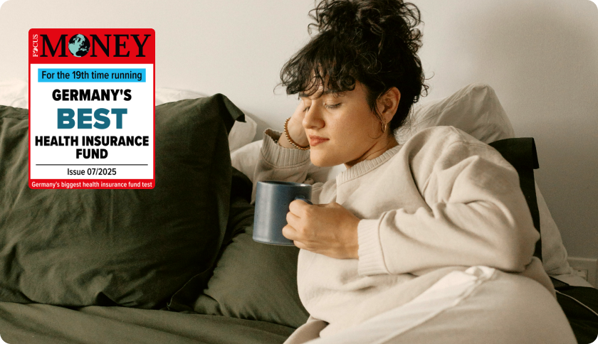 Woman relaxing at home with a cup of tea. The tag reads "For the 19th time running Germany's best health insurance fund - Focus Money"