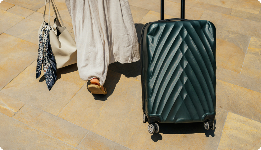 Person walking with their big suitcase and a bag.